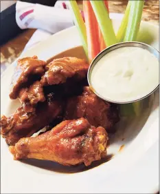  ?? Chao Pescao / Contribute­d photo ?? Buffalo chicken wings with blue cheese dressing.