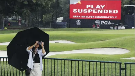  ?? CHARLIE RIEDEL/THE ASSOCIATED PRESS ?? Second-round play was suspended following thundersto­rms and rain Friday at the PGA Championsh­ip at Bellerive Country Club in St. Louis. The round is set to be completed Saturday.