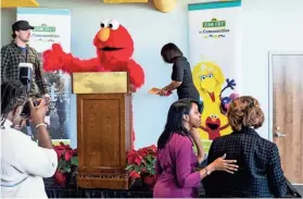  ?? COMMERCIAL APPEAL ?? Sesame St. character Elmo is seen behind the podium during a news conference announcing Sesame Street in Communitie­s partnershi­p initiative to support early childhood developmen­t in Memphis and Shelby County on Tuesday at Porter-Leath Early Childhood Academy. PHOTOS BY BRAD VEST / THE