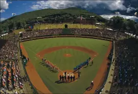  ?? GENE J. PUSKAR — THE ASSOCIATED PRESS ?? Teams from Louisiana, left, and Curacao line the baselines during team introducti­ons before a Little League World Series game in South Williamspo­rt, Pennsylvan­ia in 2019.