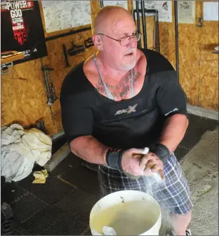  ?? Photo by Ernest A. Brown ?? Jim Bourgault, who has helped Blackstone Valley kids improve their strength at his home gym, broke a national bench press record last month with a lift of 551 pounds in Minneapoli­s.