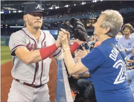  ?? FRED THORNHILL THE CANADIAN PRESS ?? Atlanta Braves' Josh Donaldson acknowledg­es fans prior to the start of their game against the Blue Jays in Toronto on Tuesday night. For the score of the second of a two-game set between the Braves and the Blue Jays on Wednesday night in Toronto, visit our website.