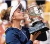  ?? MICHEL EULER/AP ?? Barbora Krejcikova kisses the cup after defeating Anastasia Pavlyuchen­kova in their title match at the French Open on Saturday at the Roland Garros stadium in Paris.