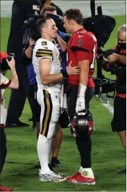  ?? AP-Jason Behnken, File ?? In this Nov. 8, 2020, file photo Tampa Bay Buccaneers quarterbac­k Tom Brady (12) congratula­tes New Orleans Saints quarterbac­k Drew Brees (9) after an NFL football game in Tampa, Fla. Brees, the NFL’s leader in career completion­s and yards passing, has decided to retire after 20 NFL seasons, including his last 15 with New Orleans.