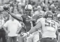  ?? Alonzo Adams / Associated Press ?? Quarterbac­k Kyler Murray hit the ground running and passing after sitting out Oklahoma’s first offensive possession Saturday.