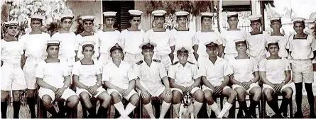  ??  ?? Commanding Officer Lieutenant Aubrey Wise, Actg. Sub Lieutenant Clancy Fernando seated in front with a dog at his feet with ship’s complement of H.M.Cy.S. Aliya at ‘Honey Moon Cottage Pier’ at Naval Dockyard Trincomale­e. Interestin­gly enough the cap tallies of the sailors carry the words H.M.Cy.S. Coastal Forces.