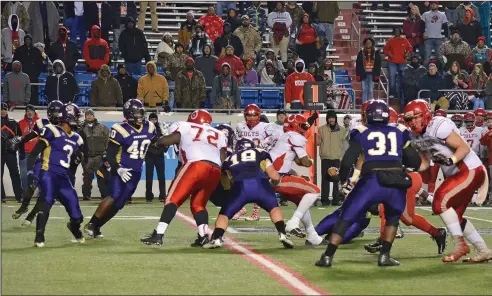  ?? Leanna Hanry/Special to the News-Times ?? Battle in the trenches: Junction City's Brock McGoogan (18) tries to bring down Rivercrest's Demilon Brown during the 3A state championsh­ip game at War Memorial Stadium in Little Rock on Friday. The Colts topped the Dragons 48-14 to win the state title.