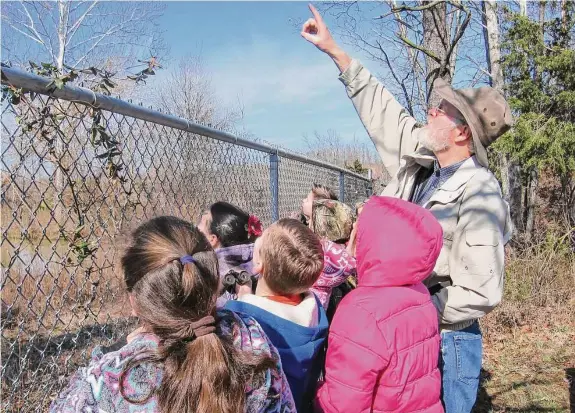  ?? Steve Kistler/Janet Kistler via AP ?? Steve Kistler teaches third graders at the Cub Run Elementary School in Kentucky about birds during the Great Backyard Bird Count in February 2012. The count is a citizen science project that collects data used by researcher­s to track bird population­s.