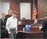  ?? Shannon Ballew ?? Robert Aaron Long, 22, is escorted into a Cherokee County courtroom in handcuffs for a plea and sentencing hearing.