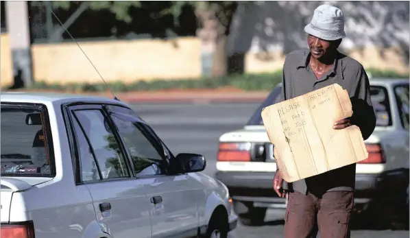  ?? PICTURE: JOHN WOODROOF ?? WEALTH GAP: Nicholas Ndogena begs at a Sandton intersecti­on. It is for the upliftment of people like him, says the writer, that competitio­n must be regulated.