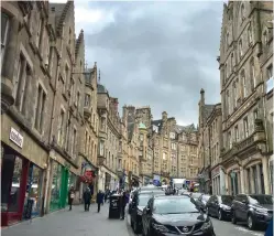 ??  ?? HUSTLE & BUSTLE: One of the typical residentia­l-and-retail streetscap­es in the Scottish capital of Edinburgh, with buildings of mottled stone blocks.