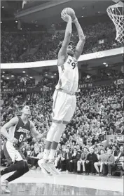  ?? Frank Gunn Canadian Press ?? LUCAS NOGUEIRA dunks over the Lakers’ Jordan Clarkson in a game the Raptors dominated.