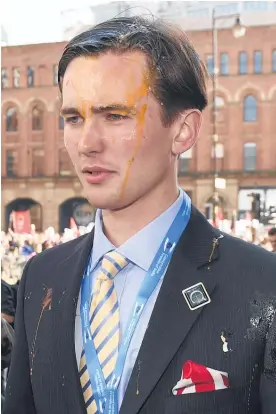  ??  ?? A Conservati­ve Party delegate, Colm Lock, has egg on his face after being targeted by activists during an anti-austerity rally in Manchester.