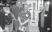  ?? SUBMITTED PHOTO ?? From left, Chuck Erickson (Duke of Pearl), Jeff Harding, Larry Sifel and Grit Laskin at the C.F. Martin & Co. booth at NAMM with the display of The Night Dive model.