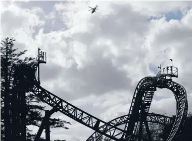  ??  ?? An air ambulance flies over the Smiler roller coaster at Alton Towers, England, after two carriages collided.