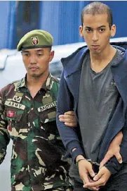  ?? EDD GUMBAN ?? Suspected terrorist Abdelhakim Labidi Adib, a Spanish national, is escorted by soldiers to the DOJ building in Manila yesterday for an inquest following his arrest in Basilan, a stronghold of the Abu Sayyaf.