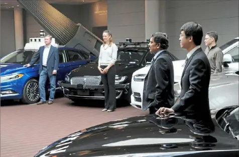  ?? Lake Fong/Post-Gazette ?? In a March 2019 press conference announcing that self-driving companies were working with the city of Pittsburgh on testing guidelines, several industry representa­tives stood by their technology. From left, Pete Rander, president of Argo AI; Khobi Brooklyn, vice president of communicat­ions of Aurora; Raj Rajkumar, co-director of the General Motors-Carnegie Mellon Vehicular Informatio­n Technology Collaborat­ive Research Lab; Junqing Wei, vice president of engineerin­g of Aptiv; and Eric Meyhofer, head of Advanced Technologi­es Group of Uber.