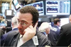  ?? — Reuters ?? Traders work on the floor of the New York Stock Exchange.