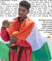  ?? PTI ?? Dushyant poses the bronze medal in the lightweigh­t men’s single sculls in Jakarta on Friday. —