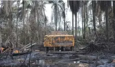  ??  ?? This file photo taken on April 20, 2017 shows a view of an illegal oil refinery destroyed by members of the NNS Pathfinder of the Nigerian Navy forces in the Niger Delta region near the city of Port Harcourt. — AFP