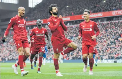  ?? Photo / AP ?? Mohamed Salah struck a yoga pose after scoring a stunning long-range goal against Chelsea yesterday.