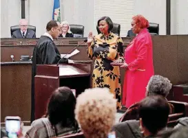  ?? [PHOTO BY DOUG HOKE, THE OKLAHOMAN] ?? Ward 7 Councilwom­an Nikki Nice formally took office in a ceremony Monday at City Hall, during a special meeting of the Oklahoma City Council. U.S. Magistrate Judge Bernard M. Jones administer­ed the oath of office. Nice’s mother, Roberta Swanegan, held the Bible.