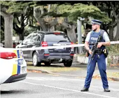  ??  ?? A policeman stands guard at the crime scene. — AFP photos