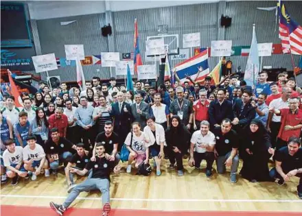  ??  ?? MASUM chairman Datuk Dr Hassan Basri Awang Mat Dahan (standing, centre) together with players and officials from the 29 participat­ing teams after the officiatin­g ceremony for the Asian University 3-on-3 Basketball Championsh­ips at the MABA Stadium in...