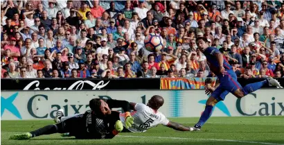  ?? AFP ?? Barcelona’s Luis Suarez (right) scores the equaliser against Valencia at the Mestalla stadium on Saturday. —