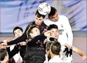  ?? AFP ?? Real Madrid’s Brazilian midfielder Casemiro (top right) heads the ball with Real Sociedad’s Spanish midfielder Martin Zubimendi (top left).