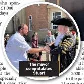  ??  ?? The mayor congratula­tes Stuart