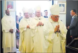  ??  ?? Monsignor Joseph A. Pepe, right, and Bishop George Leo Thomas enter the Shrine of the Most Holy Redeemer. Thomas succeeded Pepe as bishop of Las Vegas.