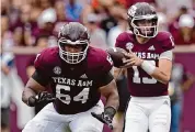  ?? David J. Phillip/Associated Press ?? Layden Robinson, left, will compete for a job protecting new Patriots quarterbac­k Drake Maye.