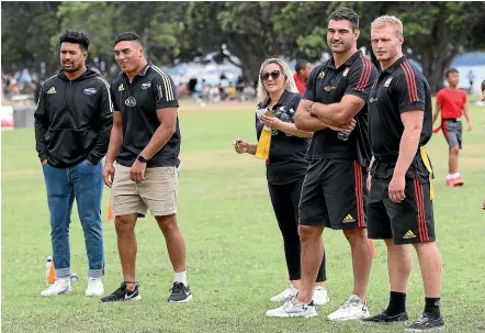  ?? GETTY IMAGES ?? Hurricanes players Ardie Savea, left, and Murphy Taramai, second from left, and Chiefs players Luke Jacobson and Sam McNicol look on at a RipRugby tournament at Misson Bay in Auckland yesterday.