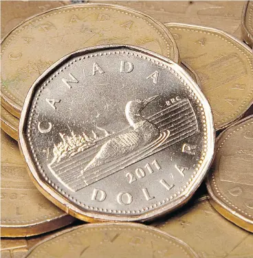  ?? JONATHAN HAYWARD / THE CANADIAN PRESS FILES ?? From a spending perspectiv­e, a higher Canadian dollar makes imports cheaper, because Canadian dollars buy more U. S. dollars, Chinese yuan or euros.