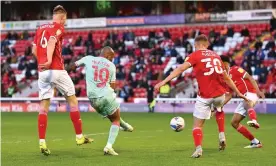  ??  ?? Swansea’s André Ayew scores the only goal of the game at Oakwell to put his side in command of their Championsh­ip play-off semi-final with Barnsley. Photograph: Laurence Griffiths/Getty Images