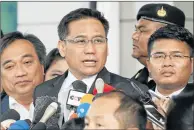  ?? Pictures: AFP ?? DARK DAY: Norawit Larlaeng, centre, head lawyer for former Thai prime minister Yingluck Shinawatra, addresses the media outside the court following a verdict in Yingluck’s trial in Bangkok yesterday