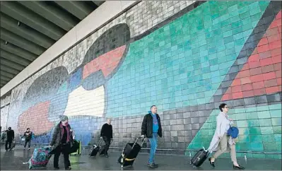  ?? XAVIER GÓMEZ / ARCHIVO ?? Pasajeros frente al mural de Miró en la terminal 2 del aeropuerto, inaugurado en 1970