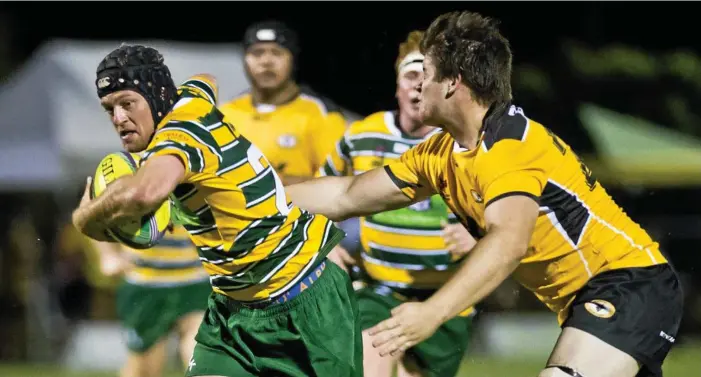  ?? Photo: Nev Madsen ?? BIG RUN: Darling Downs player Stuart Bougoure (left) attempts to break the Central Queesnland Brahmans defensive line during their Cattleman’s Cup clash.