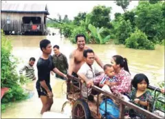  ?? SUPPLIED ?? A family vacates their home yesterday due to flooding along Stung Sen River in Preah Vihear province.