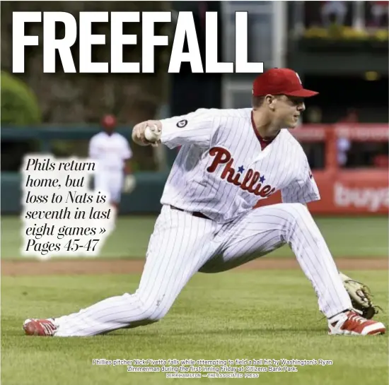  ?? DERIK HAMILTON — THE ASSOCIATED PRESS ?? Phillies pitcher Nick Pivetta falls while attempting to field a ball hit by Washington’s Ryan Zimmerman during the first inning Friday at Citizens Bank Park.