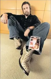  ?? Mel Melcon Los Angeles Times ?? JOHN HEFFERNAN, snakeskin boots and all, relaxes with a photo of a cobra, one of the images of deadly snakes he handed out at pitch meetings.