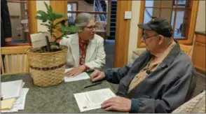  ?? PHOTO PROVIDED ?? Saratoga PLAN Executive Director Maria Trabka, left, and retired Wilton farmer Donald Tooker,right, sign papers at the closing for the sale of his property’s developmen­t rights.