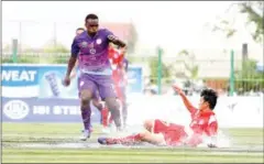  ?? SRENG MENG SRUN ?? Western Phnom Penh defender Sok Panha slides to get the ball ahead of NagaWorld striker Atuheire Kipson on Saturday.