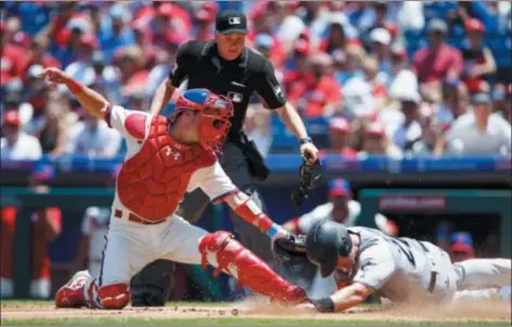  ?? MATT SLOCUM – THE ASSOCIATED PRESS ?? Phillies backup catcher Andrew Knapp, left, has earned respect in the clubhouse. The same can’t be said about what he’s done in the batter’s box. But Knapp’s lack of success there is an all-too familiar trait among the Phillies’ (lack of) supporting cast.