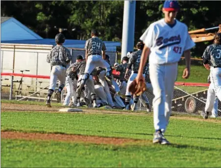  ?? AUSTIN HERTZOG — DIGITAL FIRST MEDIA ?? Members of the Norchester Legion baseball team flock to Andy Blum after he reached on an error to allow the game-winning run to cross during the ninth inning of Sunday’s game against Boyertown.