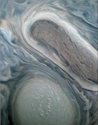  ?? KEVIN M. GILL _ NASA/JPL-CALTECH/SWRI/MSSS ?? This image shows two of Jupiter’s large rotating storms, captured by Juno’s visible-light imager on Nov. 29.