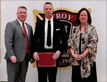  ?? COURTESY TROY FIRE DEPARTMENT ?? Firefighte­r James Bertolino, center, is honored by Fire Chief Peter Hullinger and City Councilwom­an Ellen Hodorek at a recent ceremony.