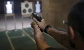  ??  ?? A pistol is fired during a practice session at the Calibre 12 gun club in Sao Goncalo. Women’s rights campaigner­s in Brazil are dismayed by Jair Bolsonaro’s loosening of gun laws. Photograph: Léo Corrêa/AP