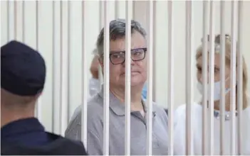  ?? — AFP ?? Opposition politician and banker Viktor Babaryko, charged with corruption and money laundering, stands inside a defendants’ cage during his sentencing in Minsk on Tuesday.